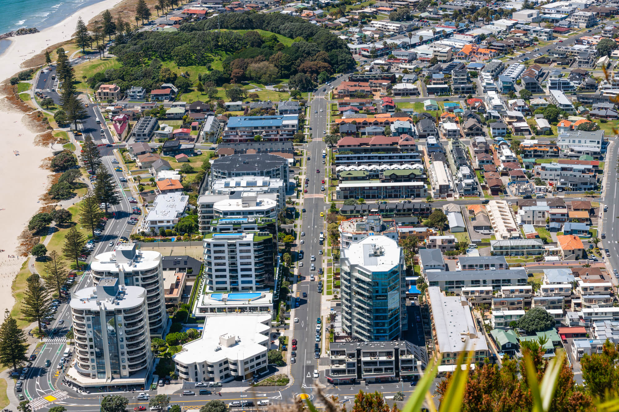 Tauranga window tinting near me - View from top of Mount Maunganui, Tauranga, over high-rise commercial and apartment buildings below, New Zealand.